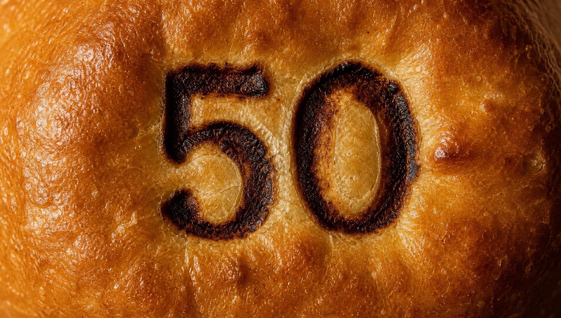A toasted burger bun with the numeral 50 branded into the crust